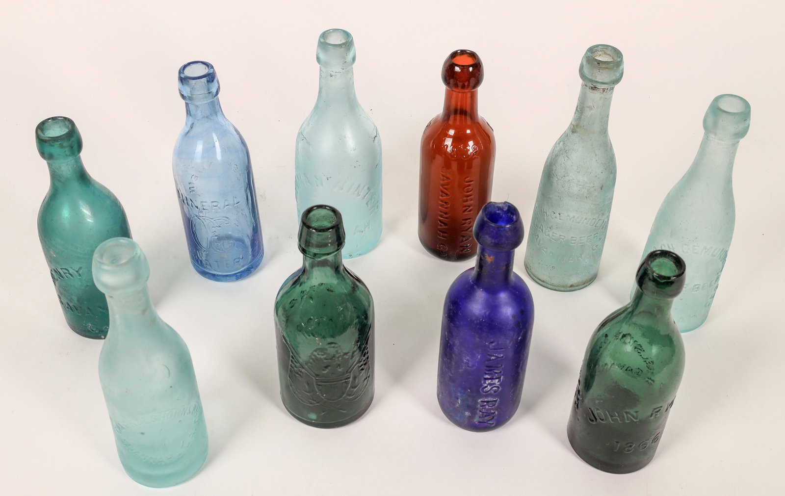 Savannah Beer and Soda Bottles, 10 [168405]: 10 Savannah beer and soda bottles. Dark aqua Henry Kuck-several small dings. Light cobalt C Ebberwein Mineral Water. Aqua Geo. Ch. Gemunden/Lager Beer. Dark aqua Excelsior Soda Works//John Ryan 1866-1