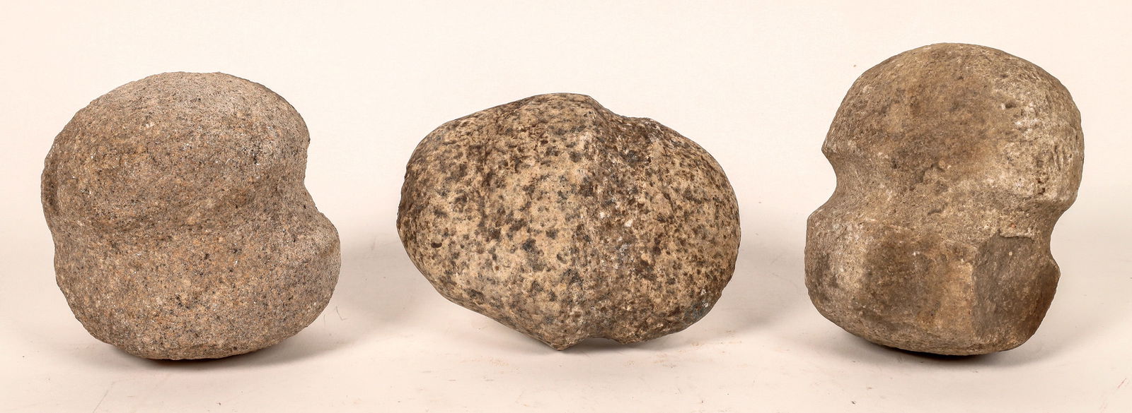 Two-Grooved Stone Axes (3) Early Archaic Period [170393]: These are three two grooved stone axes, 4.5 in., 5. in, 5.5 in. in length. All are granite, site location is unknown. Early Archaic Period 9,000-8,000 BP.