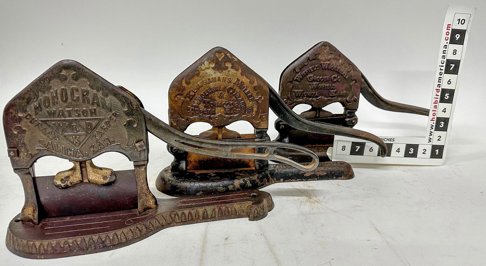 Embossed Cast Iron Plug Tobacco Cutters (3) [172549]: Collection of 3 different plug tobacco cutters. 1) Monogram // Watson, Durand, Kasper / Salina, KS. Possibly pre-1900. Broken top on one side, 1" of top gone. 2) Kingman & Miller / Wholesale Cigars an