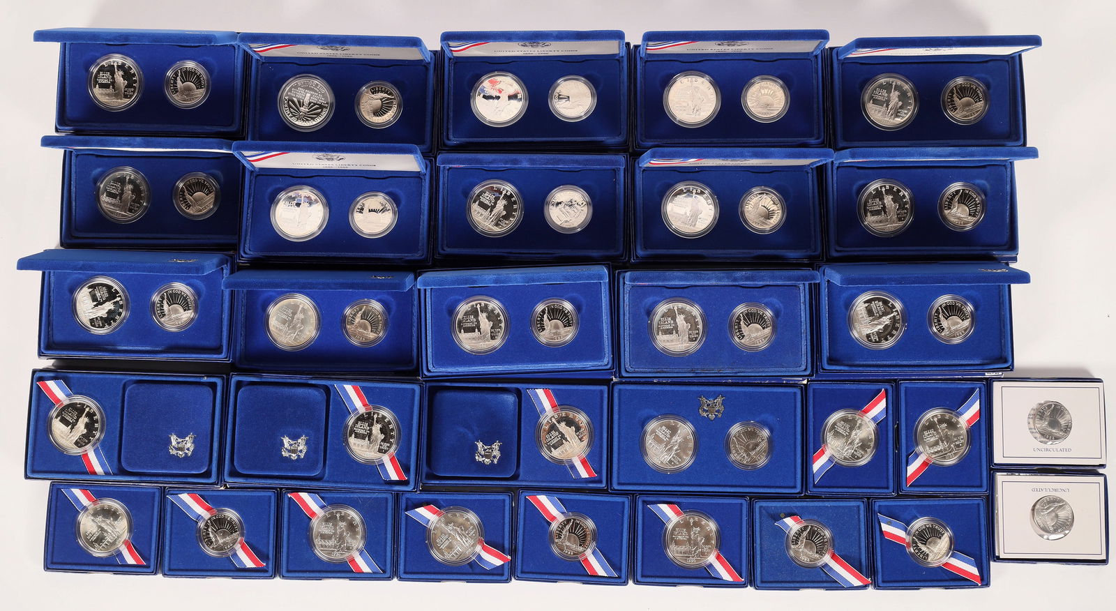 Statue of Liberty Silver Dollar & Half Dollars 1986 [173937]: In original mint packaging. Designed by John Mercanti, this .900 fine silver dollar commemorates Ellis Island as the "Gateway to America." The U. S. Mint made four different issues: Silver Proof One D