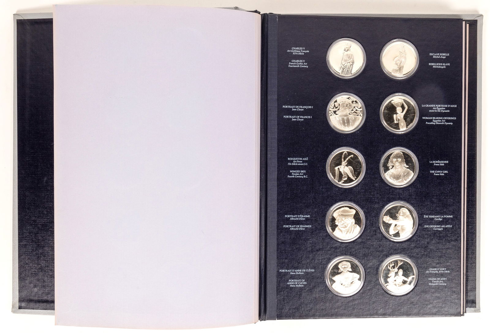 Franklin Mint: Treasures of the Louvre [169868]: First edition proof set struck by the Franklin Mint, celebrating the treasures of the Louvre. Thirty four medals are included; sixteen holes are empty. The album is 12 x 16 x 3 inches. Mintage 7792; 4