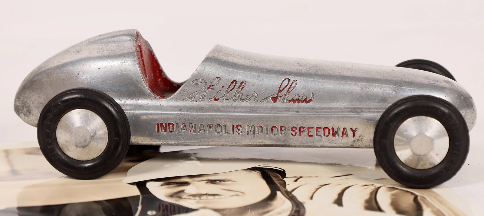 Wilbur Shaw Photograph & 1940 Model Racer [179066]: Signed facsimile 8x10" photo and 8.5" polished aluminum Maserati Speedster that Shaw drove to victory in 1937 and 1939. Ex Richard Merkin Collection and with COA from Hake's Americana. "Warren Wilbur 