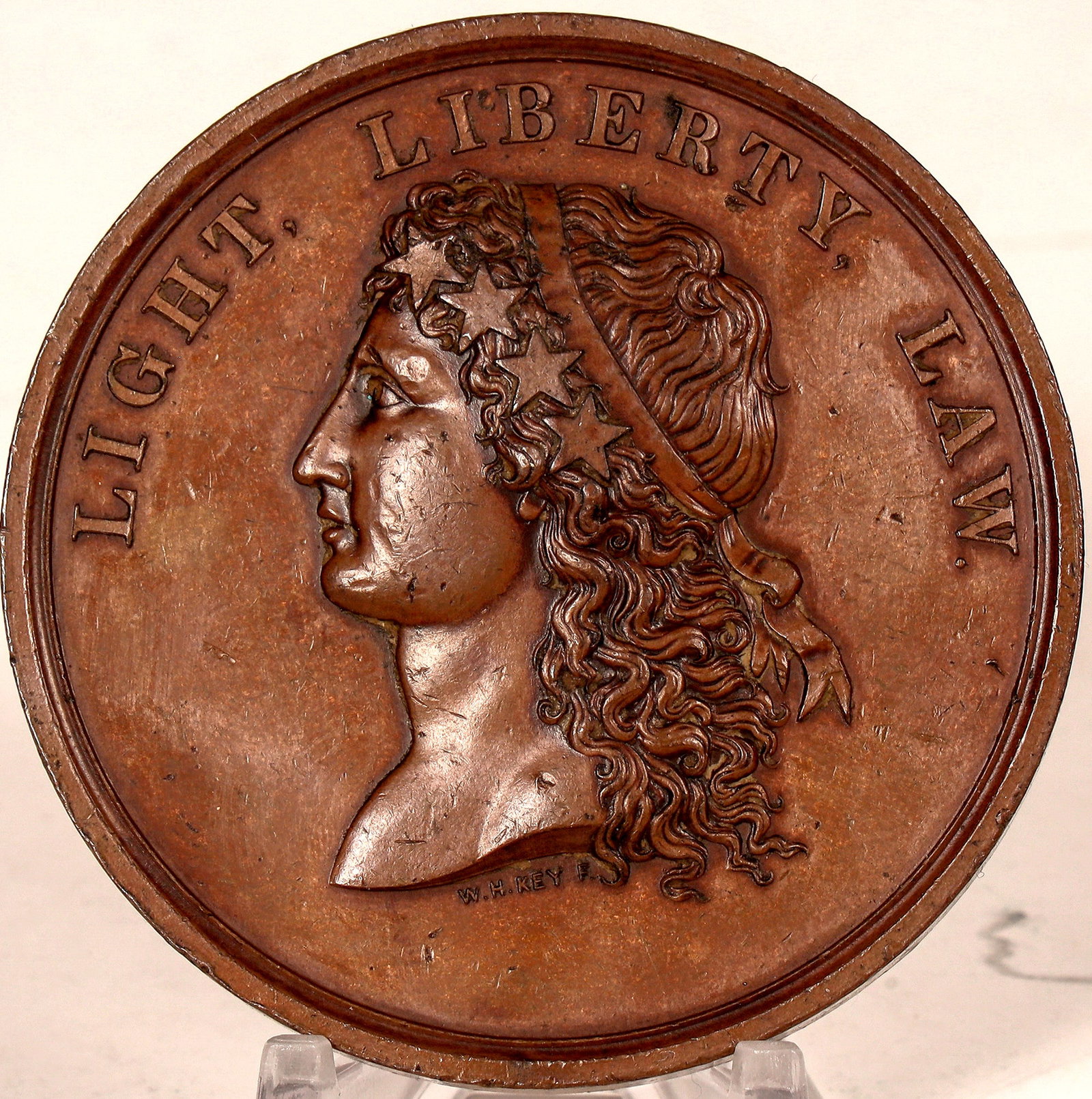 College of the City of New York Medal [180420]: Obv.: Light / Liberty / Law / (lady's head); Rev.: The New York Free Academy / Was Founded / 1847 / By Act Of The Legislature / And / Vote of the Citizens / And / Its Name Was Changed / 1866 / By Act