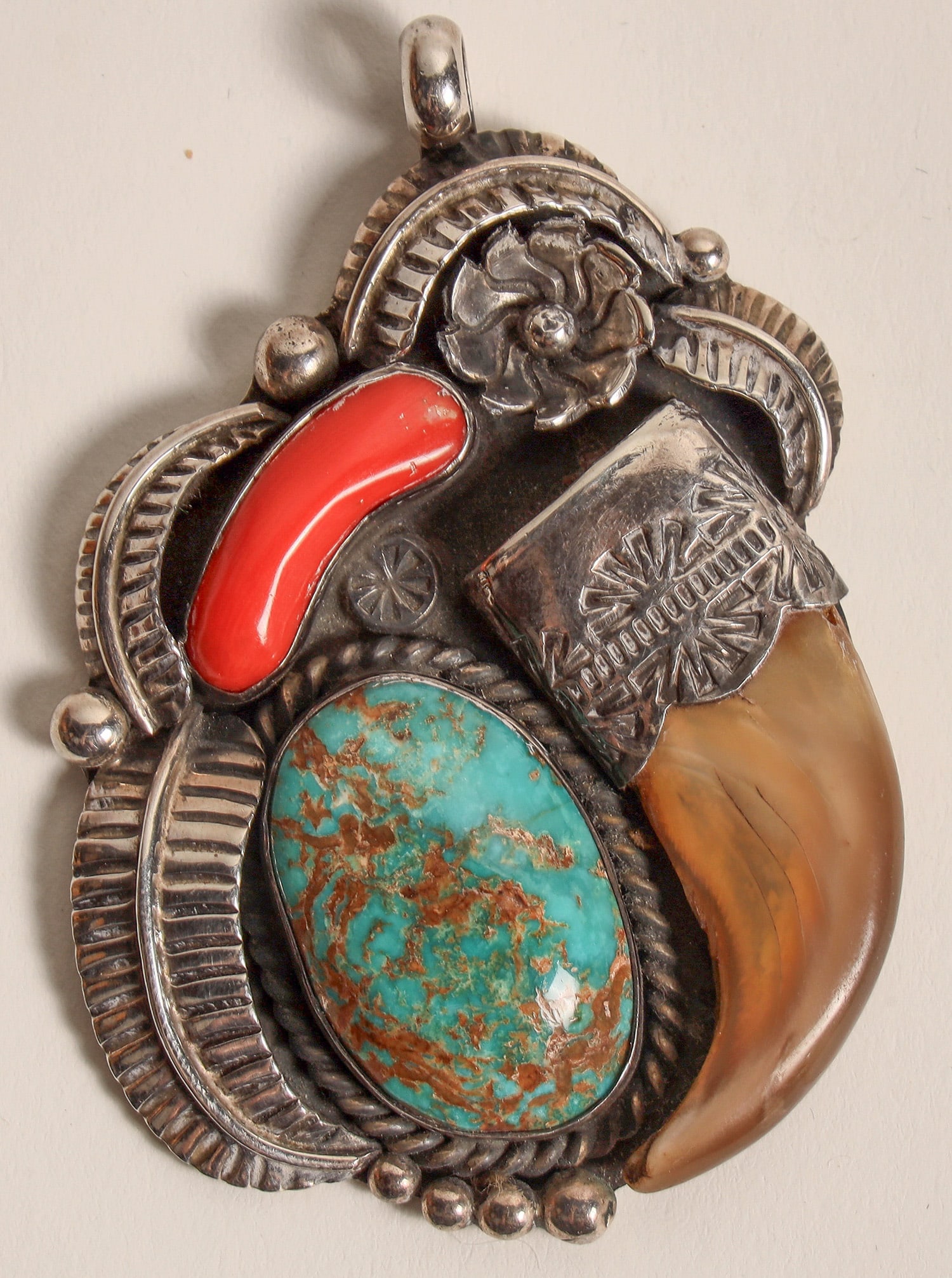 Navajo Turquoise, Coral, Claw Pendant set in Silver [186292]: 1.5 x 2.25", signed on back JH with a human caricature underneath. We were unable to find this pairing together in various jewelry databases. Possibly John Hartman. Fine blue-green turquoise with brow