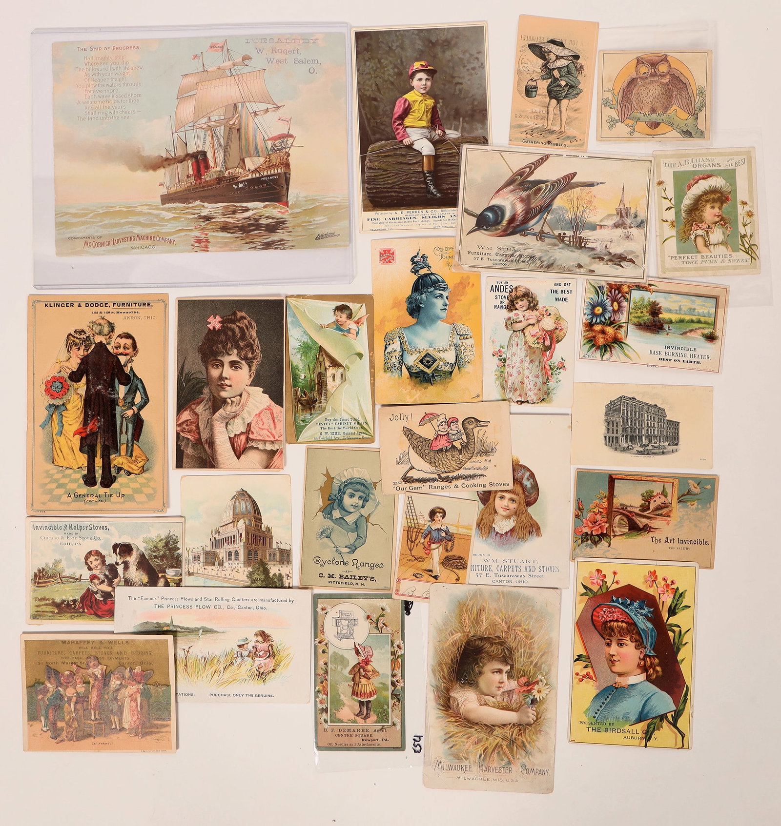 Trade Cards: Equipment (27) [180850]: Lot of 27 colorful vintage trade cards selling equipment: McCormick Harvesting Machine (large format 9 x 7 inches); stoves; carriages; plows; organs; furniture & more.
