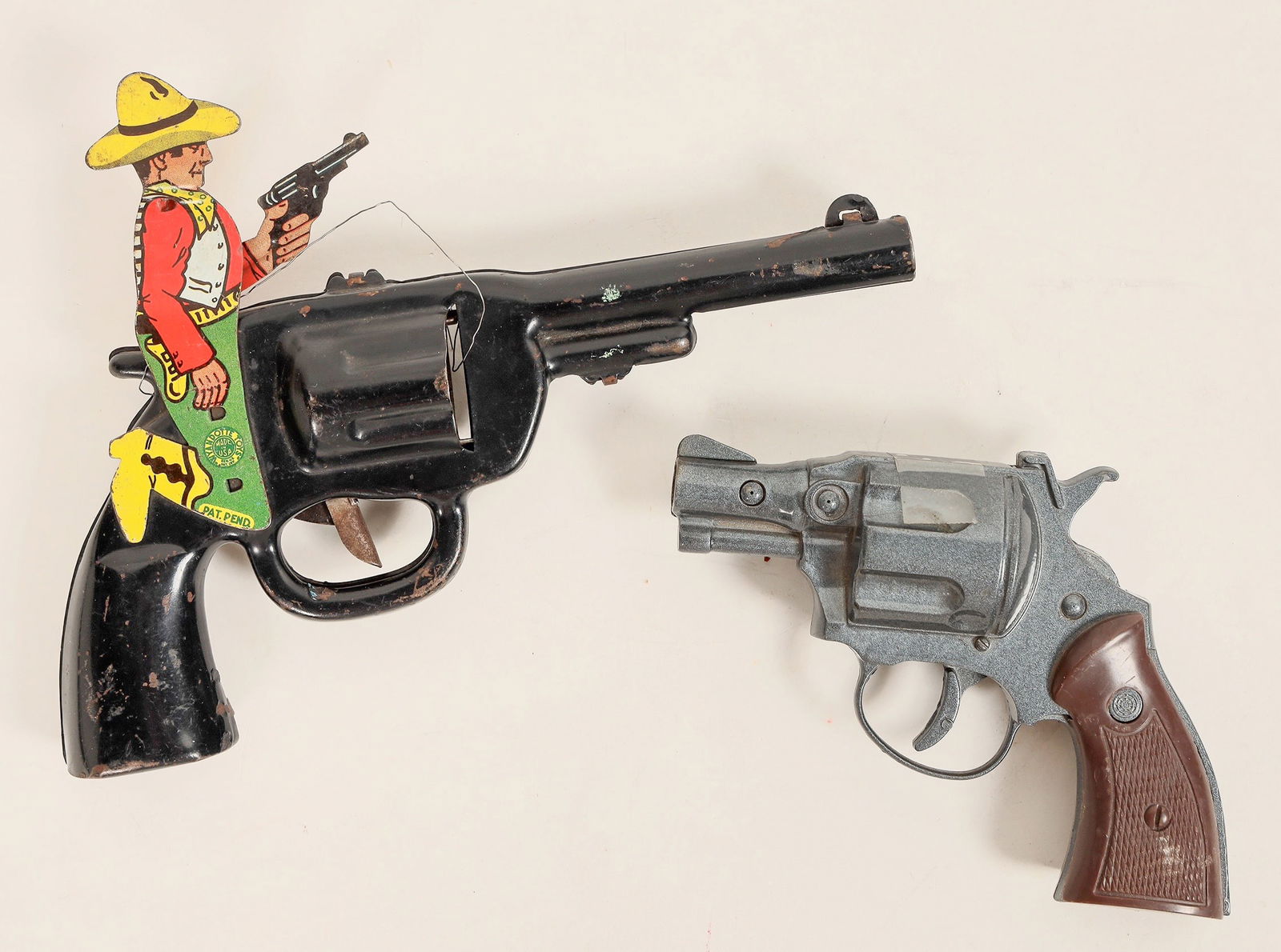 Tin Toy Revolvers [189573]: Lot of 5. 1.Two revolvers : 1950ís Me & My Buddy Pistol. Pull trigger and pistol moves. No Damage, paint on cowboy is in excellent condition. No damage notice. Standard police style cap gun, fully fu