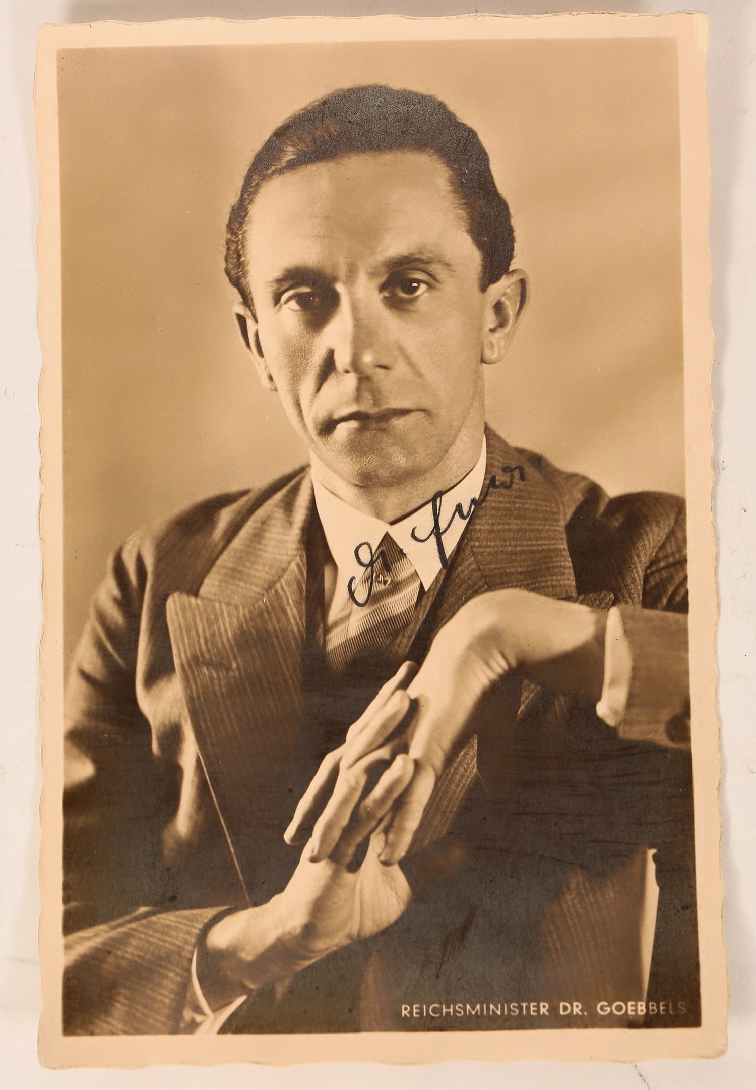Nazis- Josef Goebbels Autographed Photo [183338]: This is a signed photograph of "Dr. Goebbels" on a postcard by Hoffman. At 3.5 in. X 5.5 in. A serious Dr. Goebbels in fine dress clothing as the mastermind of German propaganda. He used such medias a