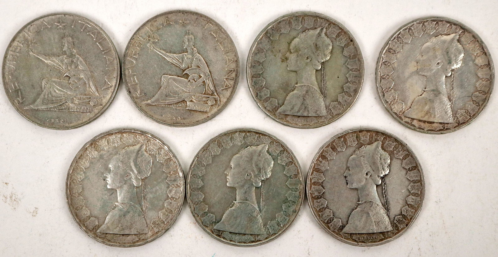 Italian 500 Lira Silver Coins (7) [191012]: Seven 500 lira coins from Italy: 1961 Italian Unification Centennial commemorative (2); Obverse: Italy seated on a capital, with her right arm raised holding an olive branch, and a helmet on her left 