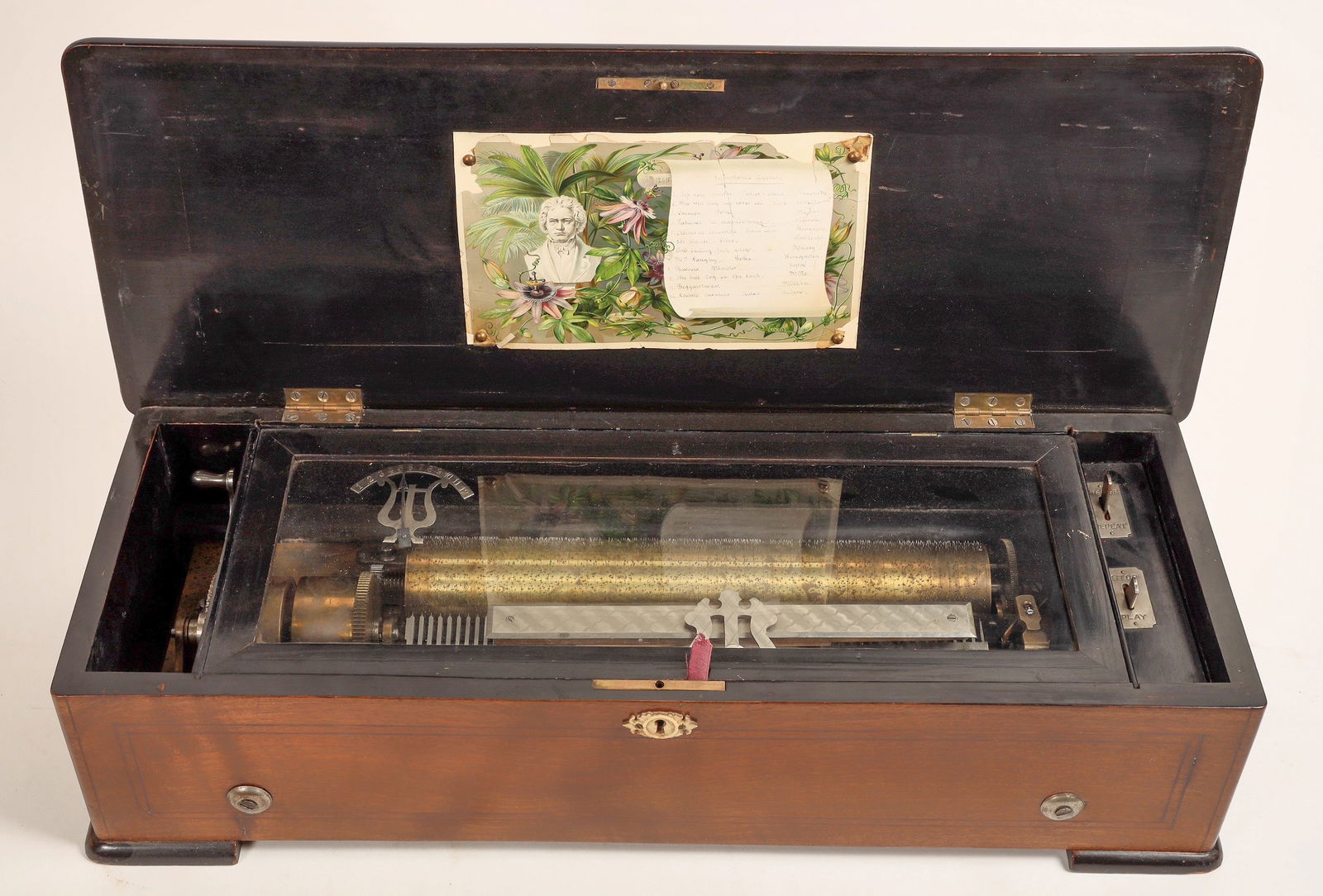 Swiss (?) Antique (?) Music Box, c 1850s (?) [188813]: Gorgeous and exquisite inlaid cherry music box, top with fancy musical instruments inlay. 8.5 x 6.5 x 24.5". The piece is made in the style of Swiss maker Le Coultre Freres of Geneva. The piece is in