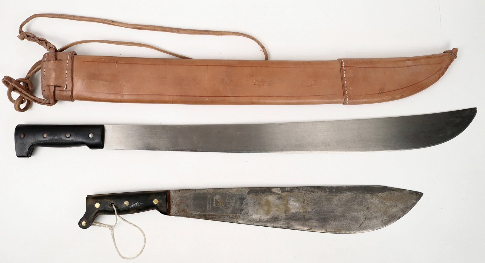 WW2 Legitimus Collins & Co. and Corneta Centroamericano Machetes (2) [193378]: A WW2 legitimus Collins & Co. 29 in. machete with a four rivet bakelite grip with leather scabbard in very good condition. The logo is an arm, hammer and crown. A second machete by "Corneta/ Producto/