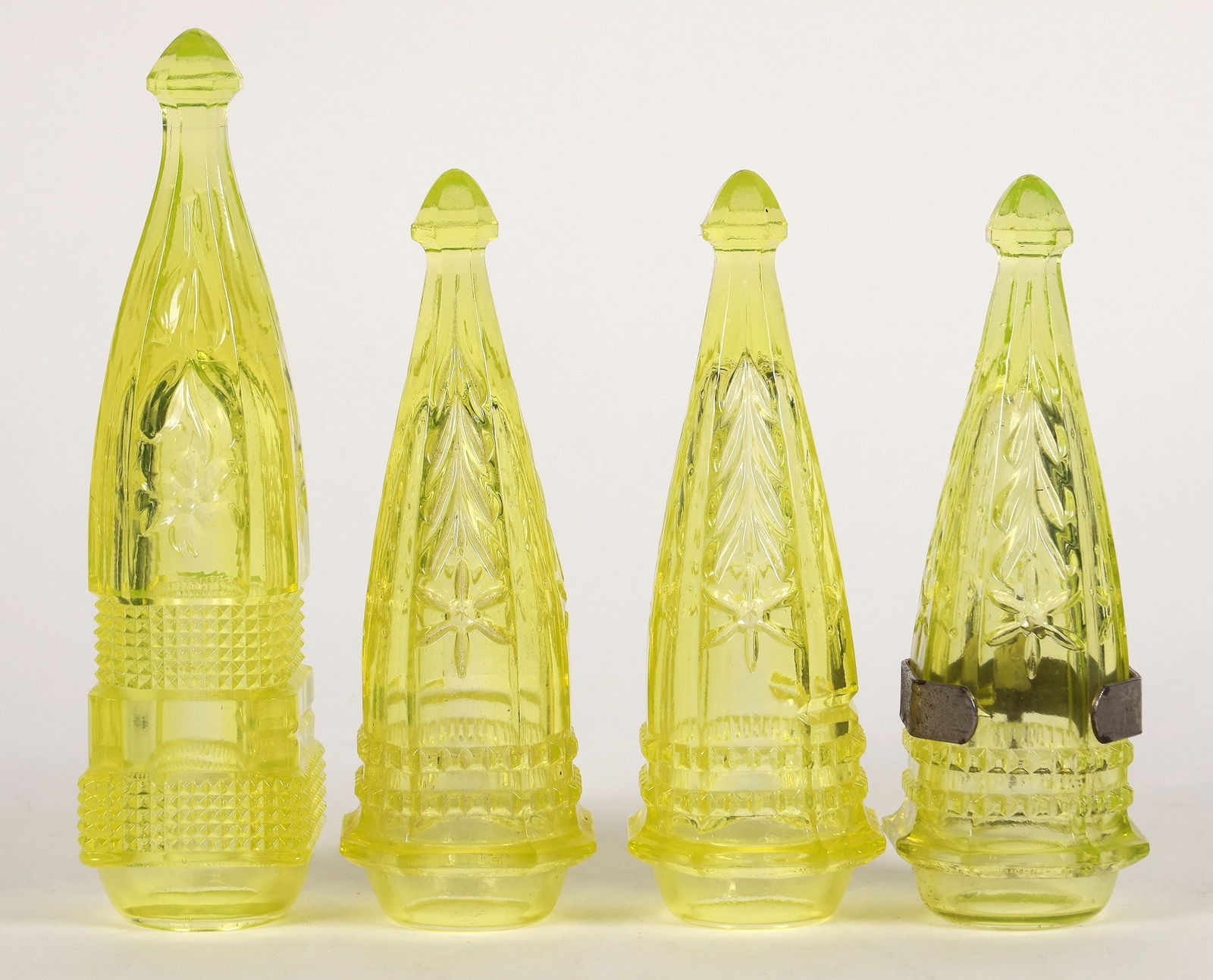 Jeannette Uranium Glass Car Vases, 4 [195112]: 4 yellow Jeanette uranium glass car vases with inward lips. 3 matched 6.25" with 1 bracket, 1x 7.5". No apparent chips or cracks. ^Date: Country (if not USA):State: City: Provenance: PLEASE NOTE: We a