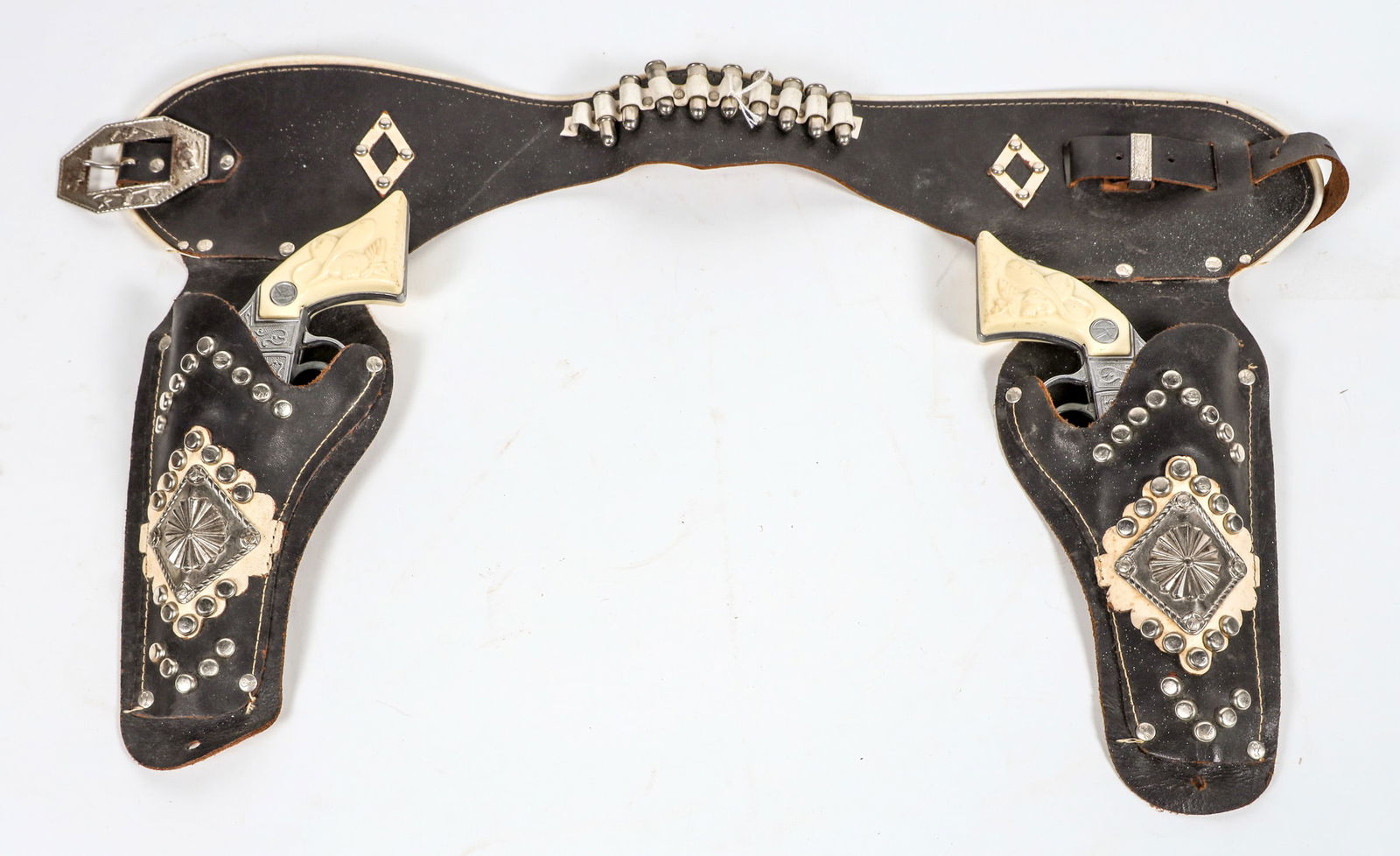 Circle K Cap Gun Pistols and Holster [196967]: This is a Circle K Ranger two cap gun and holster set. There are 9 bullets in the belt, both pistols drop the hammers and the black dyed leather is in very good condition. There are three bullets on t