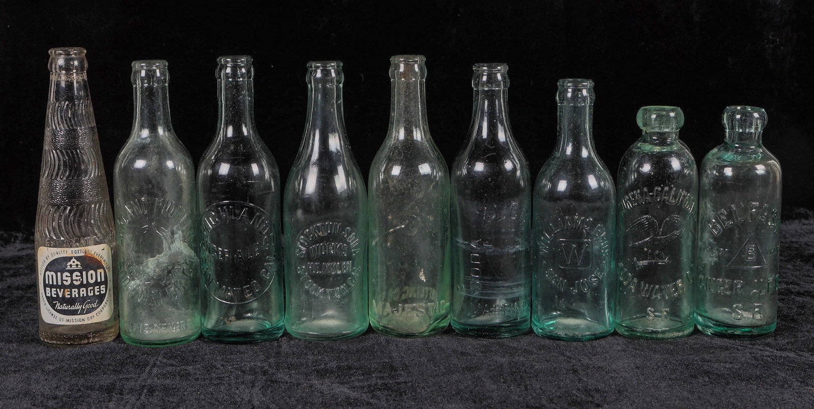Bay Area Soda Bottle Collection, 9 [194983]: 9 Bay Area soda bottles with 2 Hutch's. Crowns-Majestic, San Francisco-side ding, Oakland Pioneer, Mission, XL CR Soda Works, Martinez, Stockton Soda Works, Williams Bros., San Jose, Highland Ginger A
