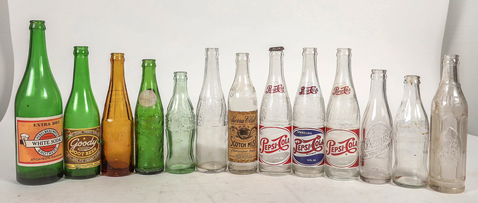 Soda Bottle Collection, 13 [195553]: 13 newer soda bottles. Coke, Dr Pepper, bubble up, Reif's Special, Chief etc. See photo/^Date: Country (if not USA):State: City: Provenance: Mike Polak "Bottle King" CollectionPLEASE NOTE: We assume l