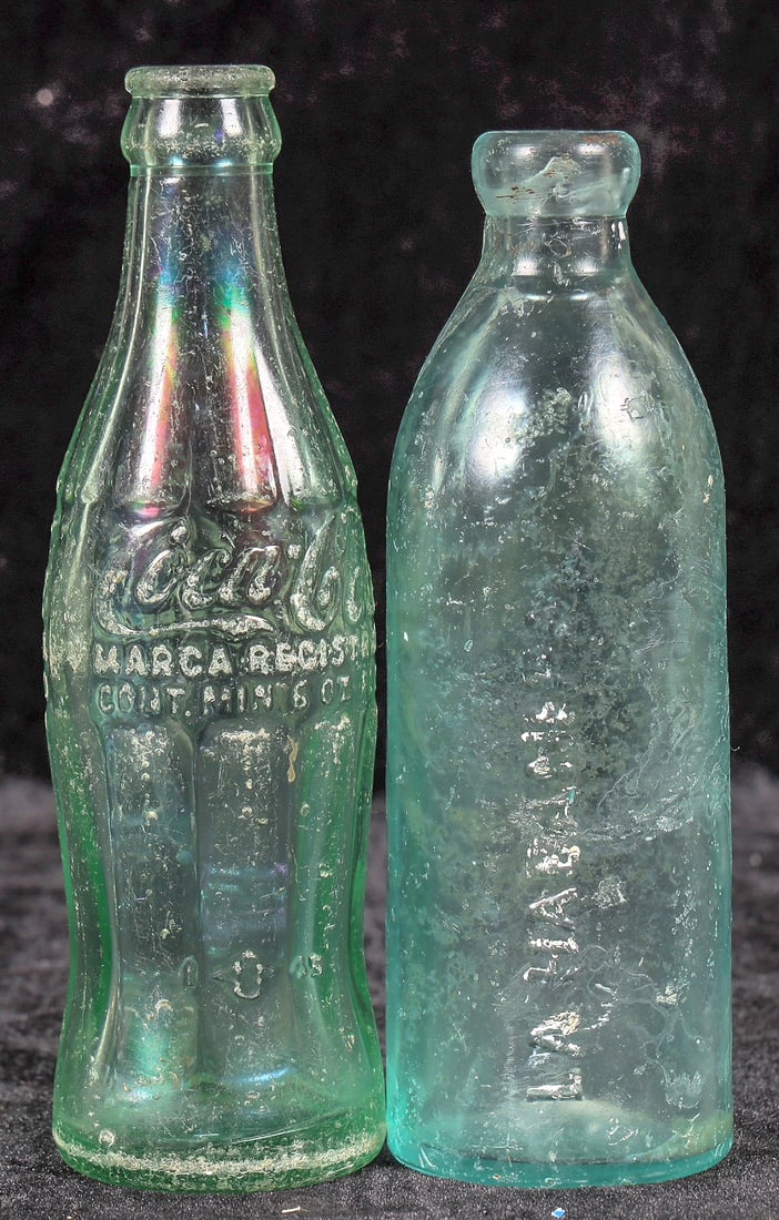 Cuba Old Coke and Soda Bottle Pair [195551]: c. 1945 Coke bottle with case wear and base bruises. Aqua La Habanera soda bottle, case wear. Please inspect.^Date: Country (if not USA):State: City: Provenance: Mike Polak "Bottle King" CollectionPLE