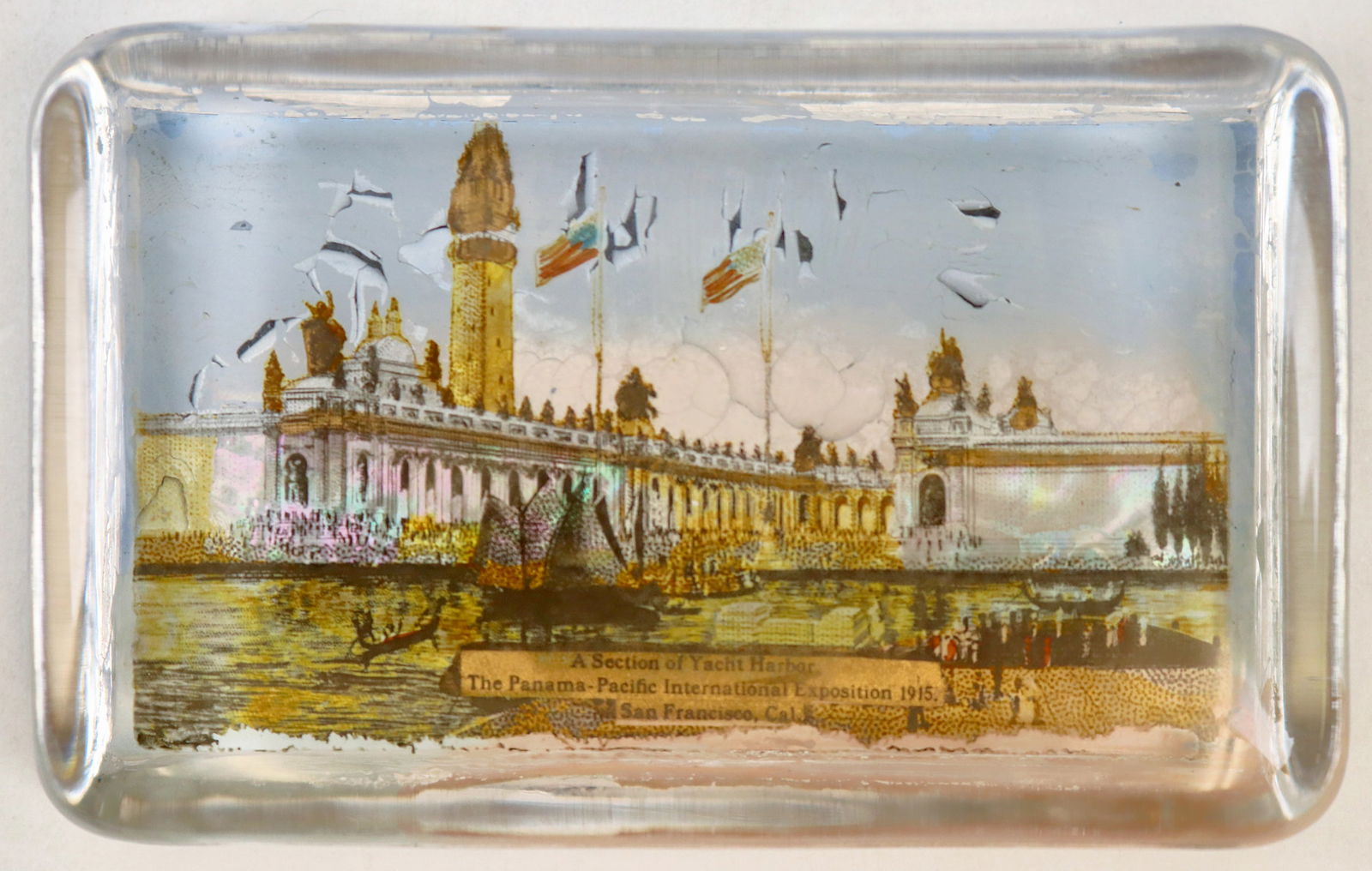 Panama Pacific Exposition Yacht Harbor Paperweight [195148]: Glass paperweight, 4 x 2 1/2 inches, 3/4 of an inch tall, with colorful image of A Section of Yacht Harbor, The Panama Pacific International Exposition 1915, San Francisco, California. Mirrored back.^