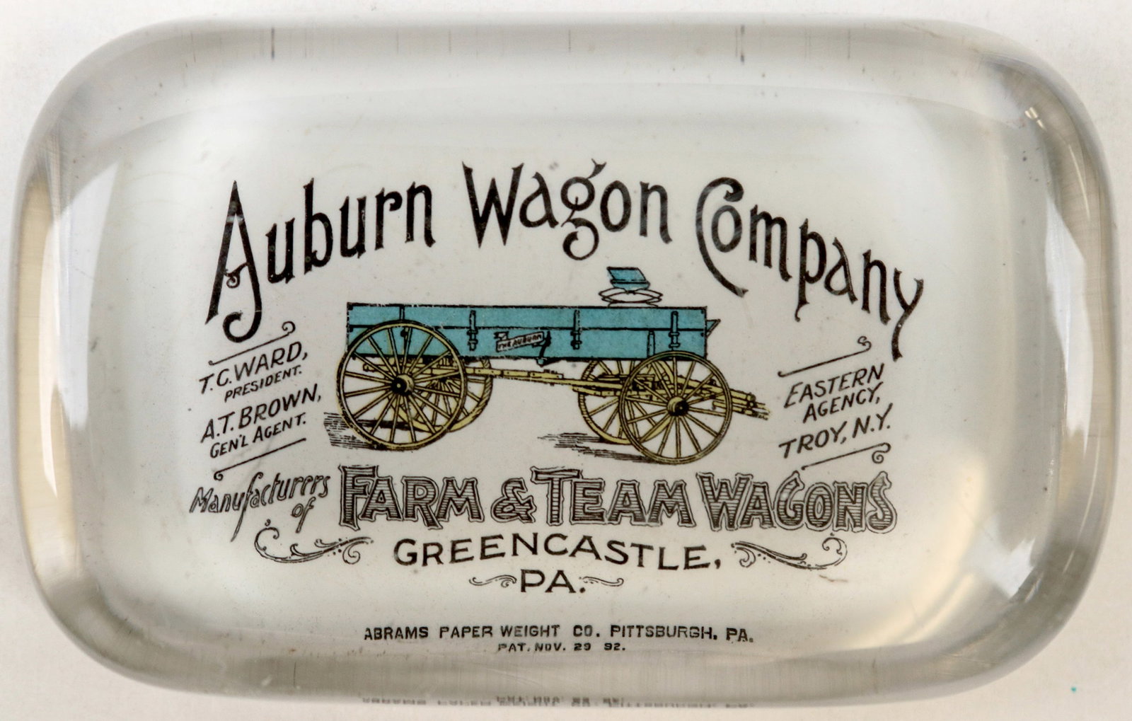 Auburn Wagon Company Glass Paperweight [195147]: Glass paperweight, 4 x 2 1/2 inches, 3/4 of an inch tall, advertising the Auburn Wagon Company, Farm & Team wagons from Greencastle, PA.^Date: Country (if not USA):State: PennsylvaniaCity: Greencastle