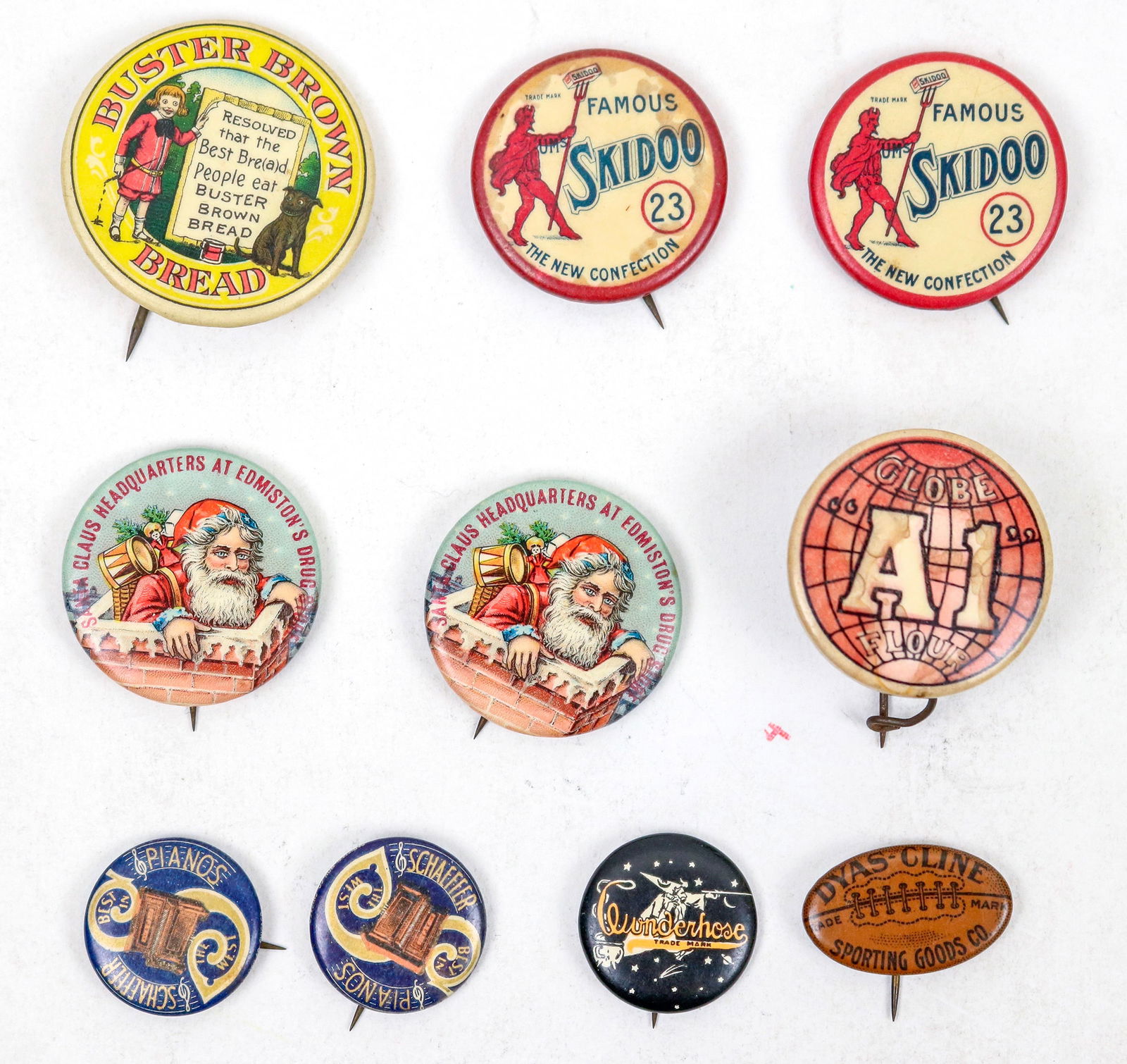 Advertising Pinbacks (10) [195160]: Ten vintage advertising pinbacks: Famous 23 Skidoo the new confection (2); Santa Claus Headquarters at Edmiston's Drug Store (2); Schaeffer Pianos (2); Buster Brown Bread; Dyas-Cline Sporting Goods; G