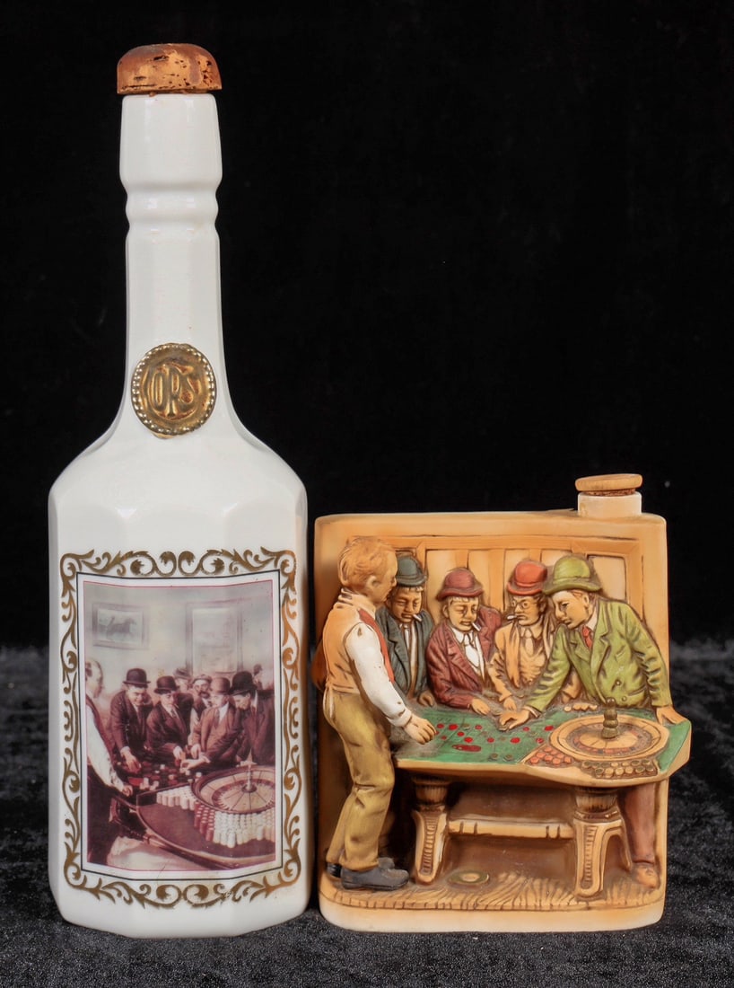 Tonopah Advertising Decanter and Cyrus Noble [195423]: White Cyrus Noble Tonopah Saloon 4/5 Bourbon bottle, 1975 Haas Brothers Tonopah Saloon gaming decanter. Both are based upon a similar roulette table image. No apparent chips or cracks.^Date: Country(i