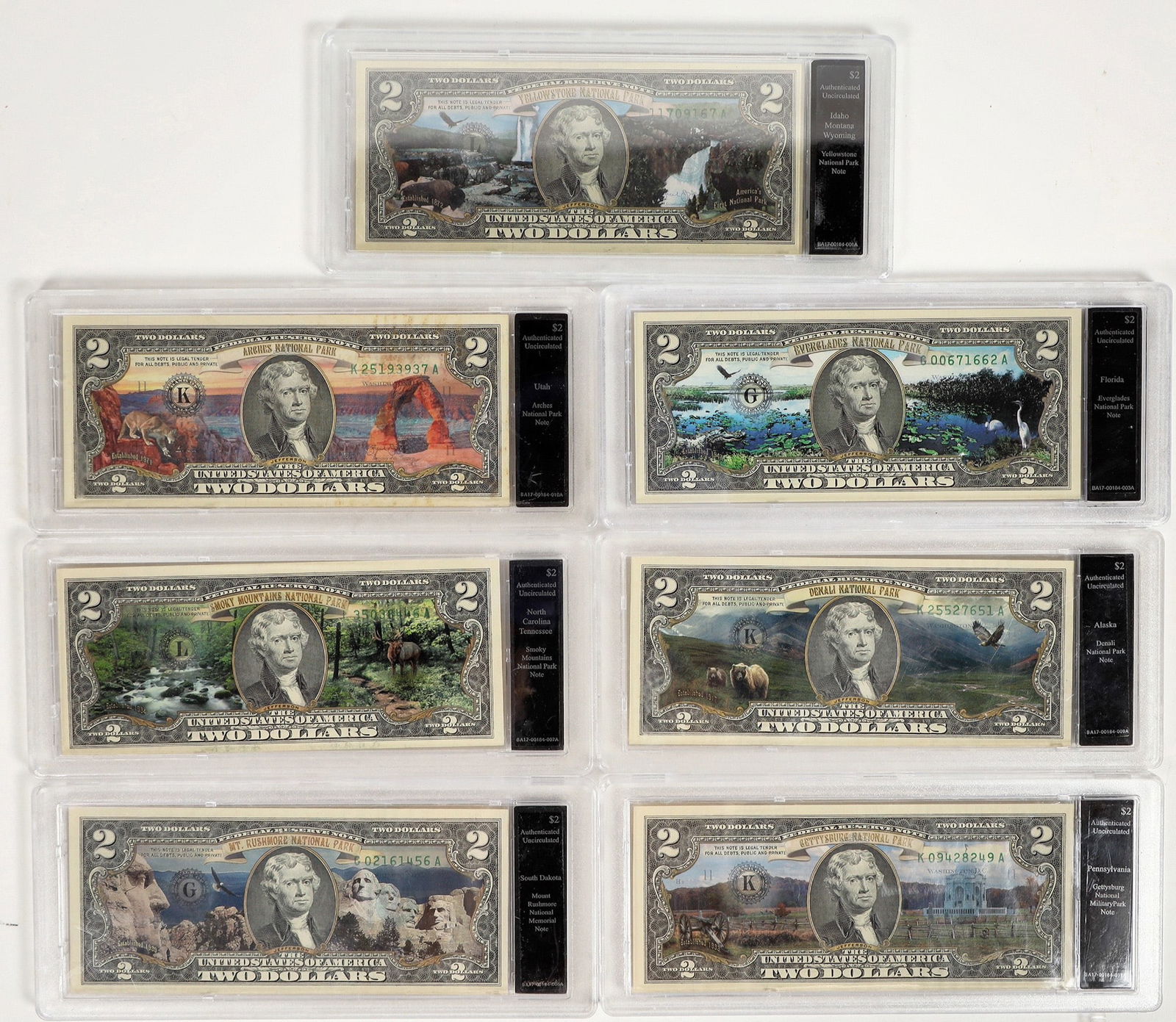 Colorized Two Dollar Bills (7) [198760]: National Parks are celebrated on these seven uncirculated two dollar bills with colorful background in hard plastic cases: Florida (Everglades); Utah (Arches); North Carolina/Tennessee (Smoky Mountain