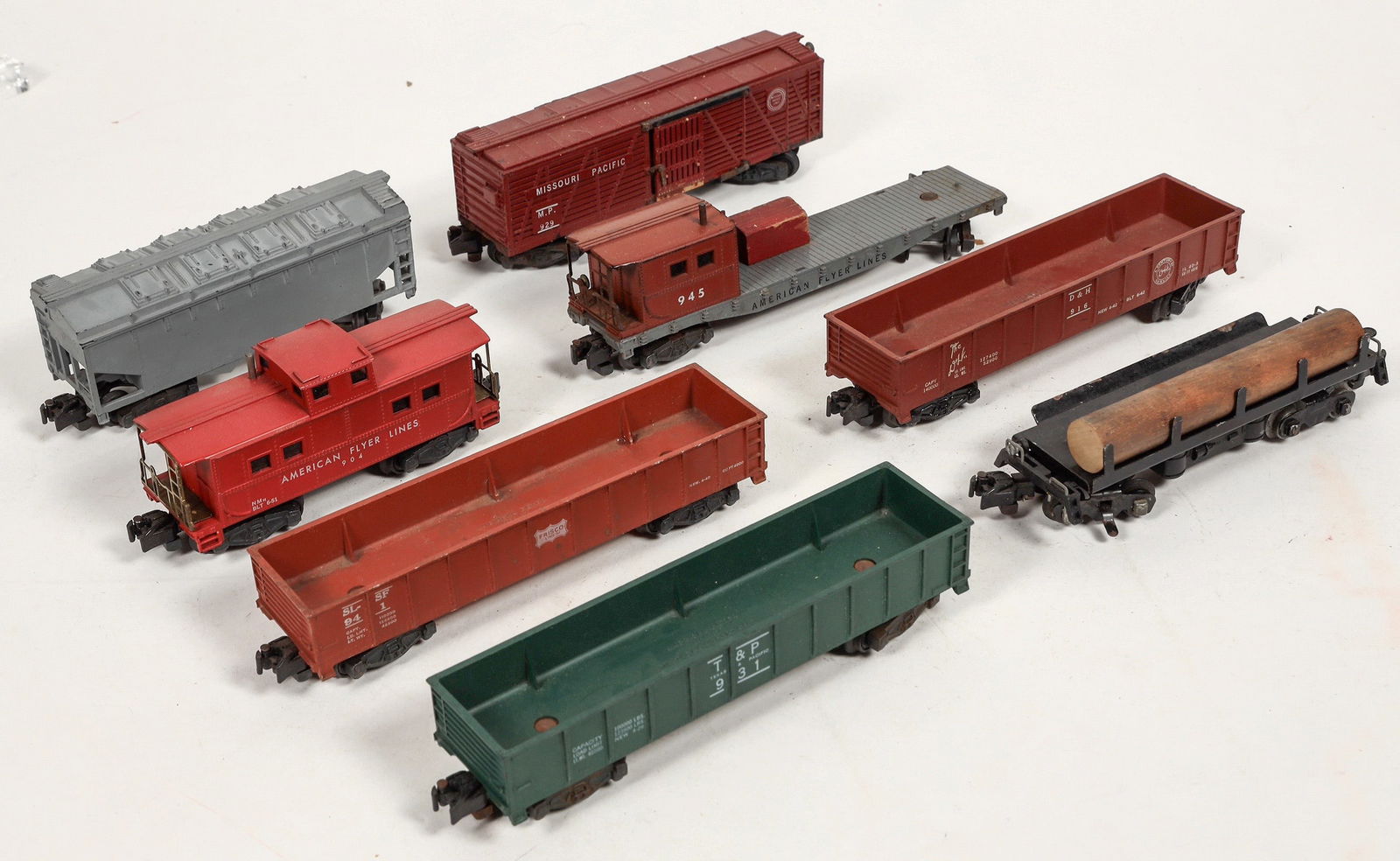 American Flyer Rolling Stock Collection [183890]: Lot of 8. C7P Cement Bottom Dumps, Three gondolas : T&P, The D&H, Friscp. Log car, 945 crane tender, 929 Missouri Pacific livestock car. Varying conditions. removed from active layout. ^Date: 1950-60'
