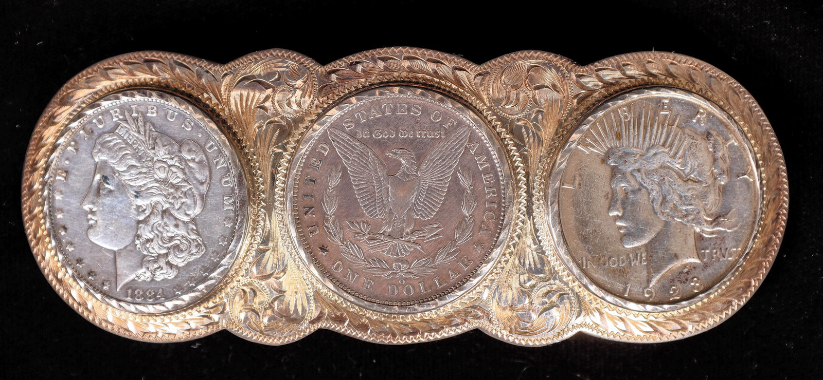 Wade's Silver Shop Silver Dollar Belt Buckle w/ Three Dollar Coins [198511]: Wade's Silver Shop created this three coin sterling silver belt buckle, it's still in the original box. An 1884 and a 1887-O Morgan, and a 1923 Peace dollar. 5 1/2 inches long, 2 inches tall. Holds up