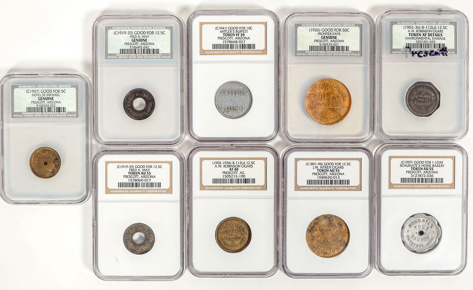 Prescott Graded Token Collection (9) [197136]: Nine graded tokens from Yavapai County: 1) Schumate's Home Bakery; GF one loaf; AU 55. 2) J. M. Aitken Cigars; GF 12 1/2c; AU 55. 3) Antler's Buffett; GF 10c; VF 30. 4) A. W. Robinson Cigars; GF 12 1/