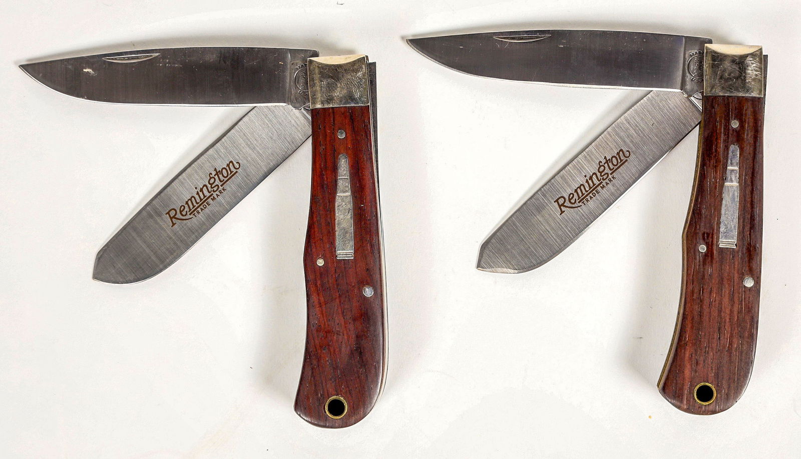 Remington Trapper model R 1128 (2) [200517]: This group has two Remington Trapper bullet knives model R1128 on cocobolo scales. New in the box with paperwork. 4. 5 in. closed. 1989 stamped on the blade. Please see photos for details. ^Date: Coun