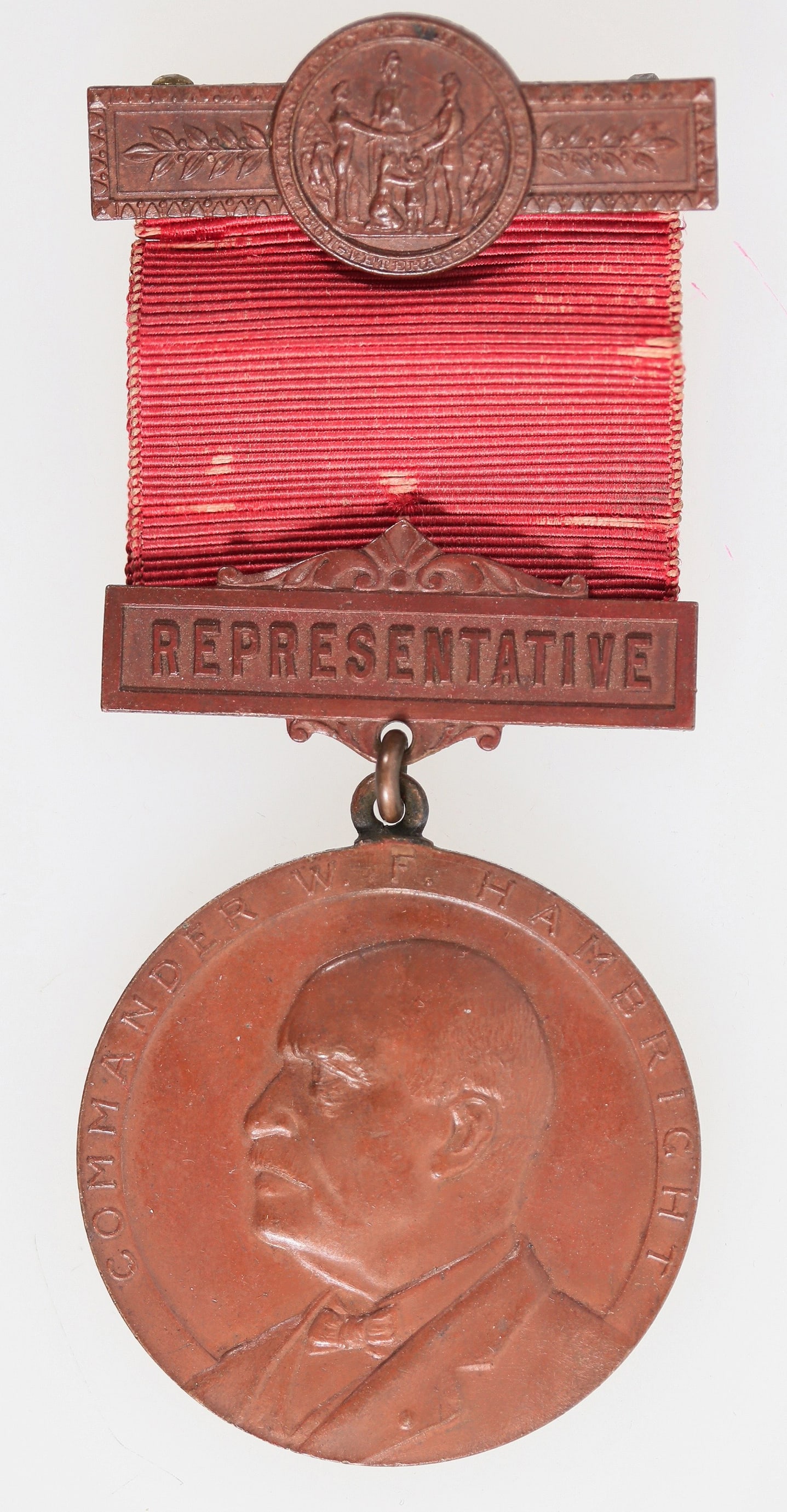 W. F. Hambright GAR Meeting Badge 1923 [200112]: The 57th annual meeting of the Civil War Veterans was held in Greenburg, Pennsylvania, June 1923. This representative's badge features Commander W. F. Hambright. The medal is 38 mm, and the pinback, i