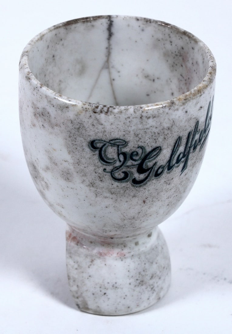 Goldfield Hotel Egg Cup (Damaged) [196370]: A ceramic egg cup from the Goldfield Hotel in Goldfield, Nevada. This cup measures 4"x 3" and the foot has a piece broken off. This particular cup was found along the railroad tracks in town. A very r