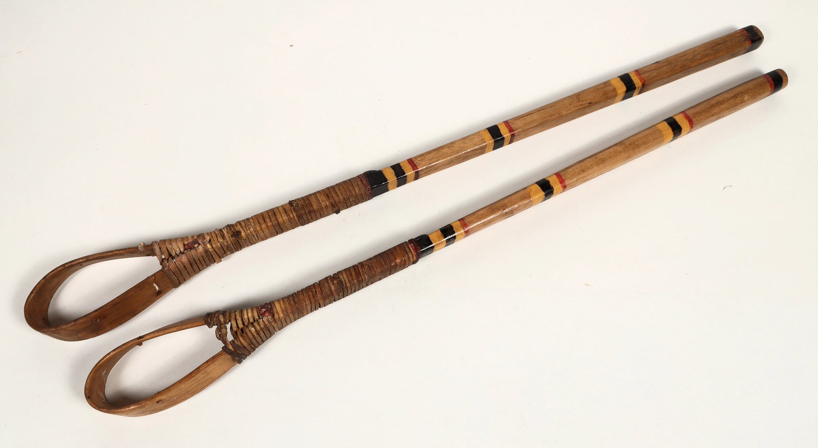 Chickasaw Stick Ball Sticks c. 1920's (2) [200494]: These are two Chickasaw Indian balls sticks or kapuchas. One measures 30 in. the other at 32 in. The center cup weaving is now missing in action. In very good condition. Both are made by the same hand