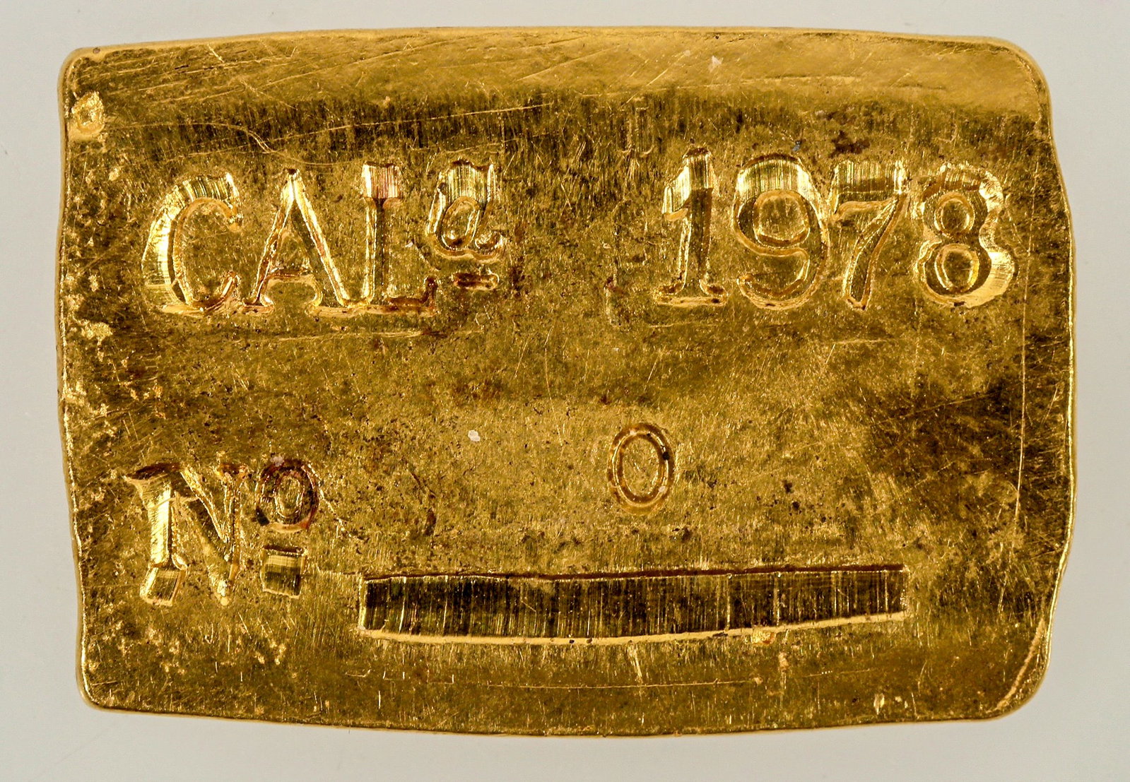 Nevada City Mint Gold Ingot [202336]: Made by Don Schmitz at the Nevada City Mint, a gold ingot made to resemble a gold rush era ingot. Obv.: Gold/ OZ 0 GR 130 / 999 Fine. Rev.: CAL 1978 / No. 0. 8.5 grams; 22 x 15 mm.^Date: Country (if n