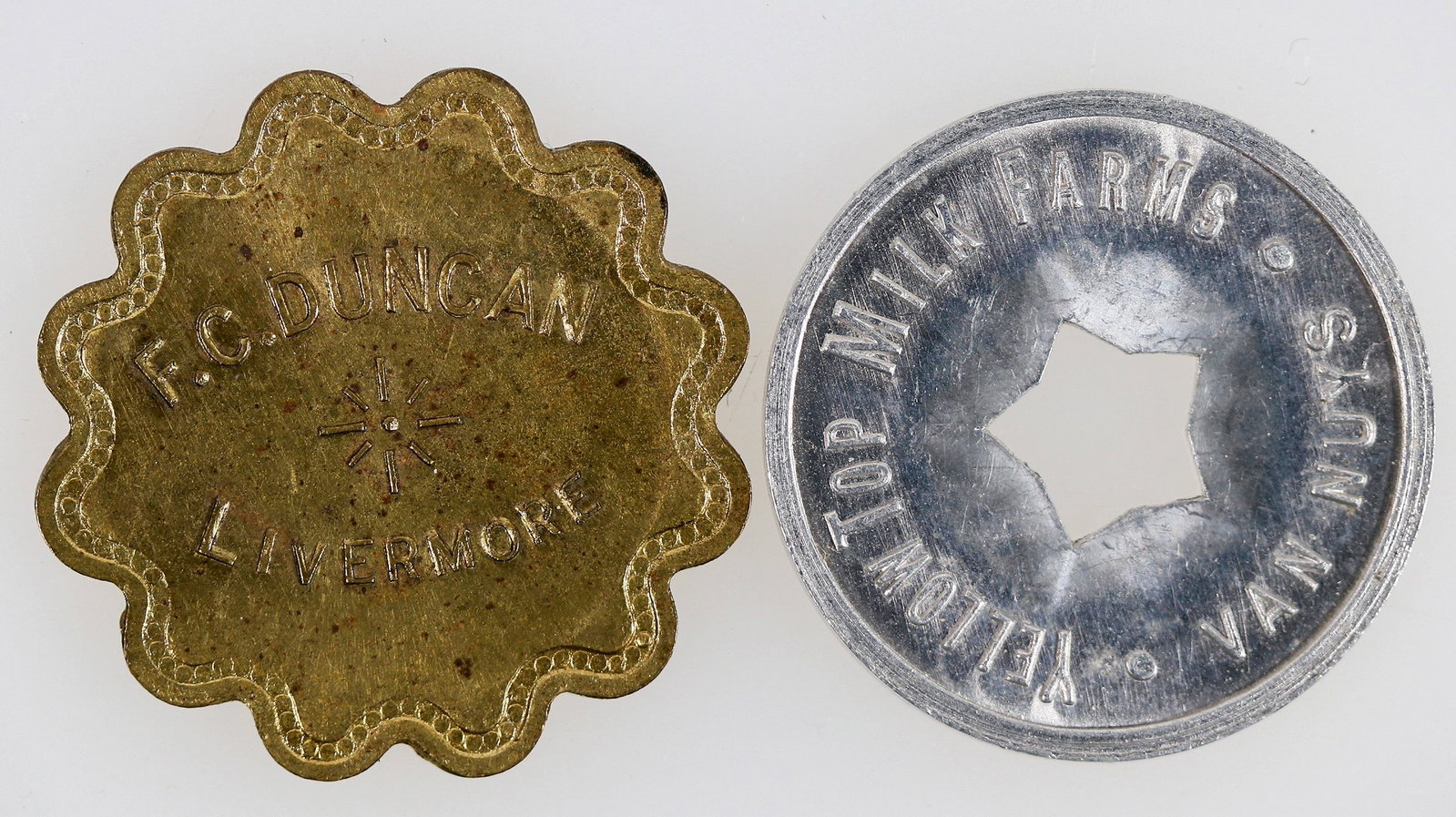 California Uncirculated Tokens (2) [204845]: Two California tokens: 1) F. C. Duncan / Livermore // 12 1/2 / Cts. / In Trade; Br., Sc 12, 26 mm. 2) Yellowtop Milk Farms / Van Nuys // One Quart / Milk; Al., rd., 25 mm, star cut out.^Date: Country 