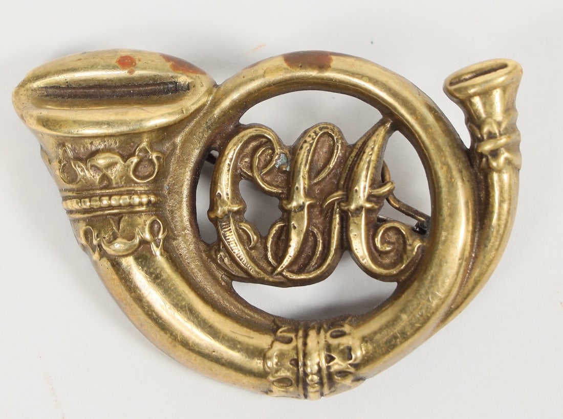 Confederate Infantry Hat Badge 1861 [201001]: This is a cast brass Confederate Civil War infantry bugle hat badge. Solid brass with "CSA" cast into the circle. A pin is soldered into the back. A circle "P" is crudely cast into the back. 2 in. lon