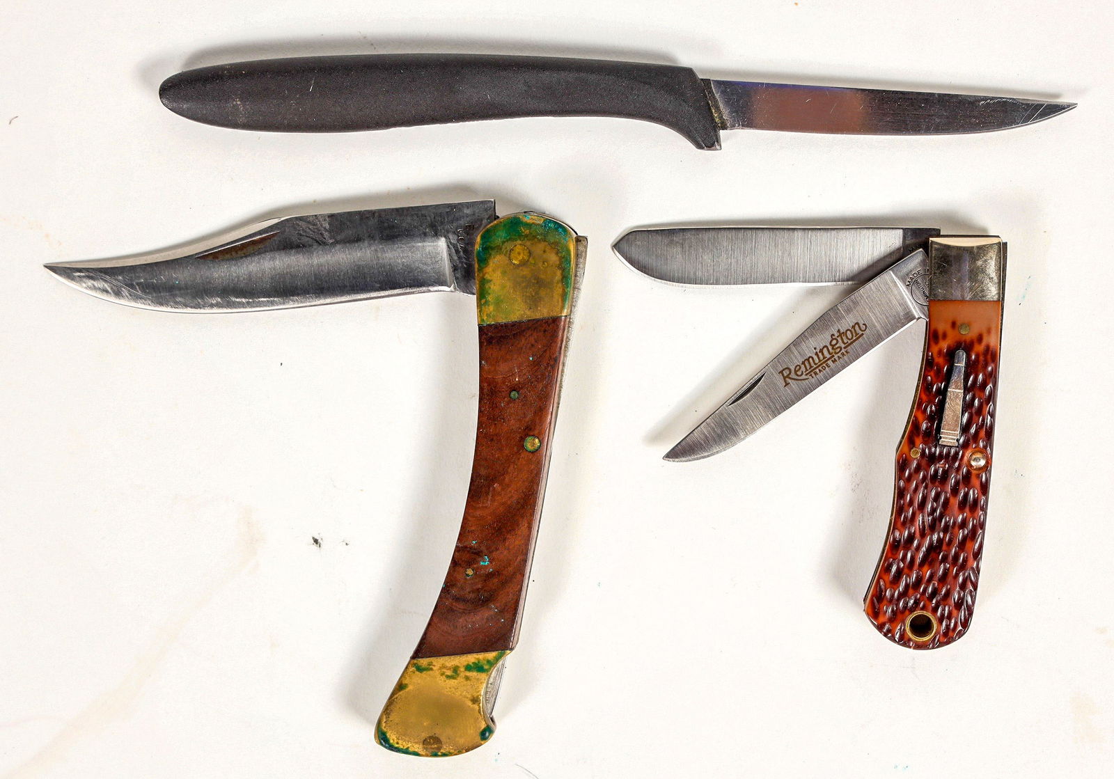 Gerber Trout-Bird Knife/ Remington Bullet Knife R 1173/ Buck 110 with Leather Sheath (3) [200535]: This three knife grouping has a Gerber Trout-Bird knife with leather sheath in like new condition. 8 in. overall length with a gut spoon on the end of the armorhide handle. C.1970's. A Remington Bulle