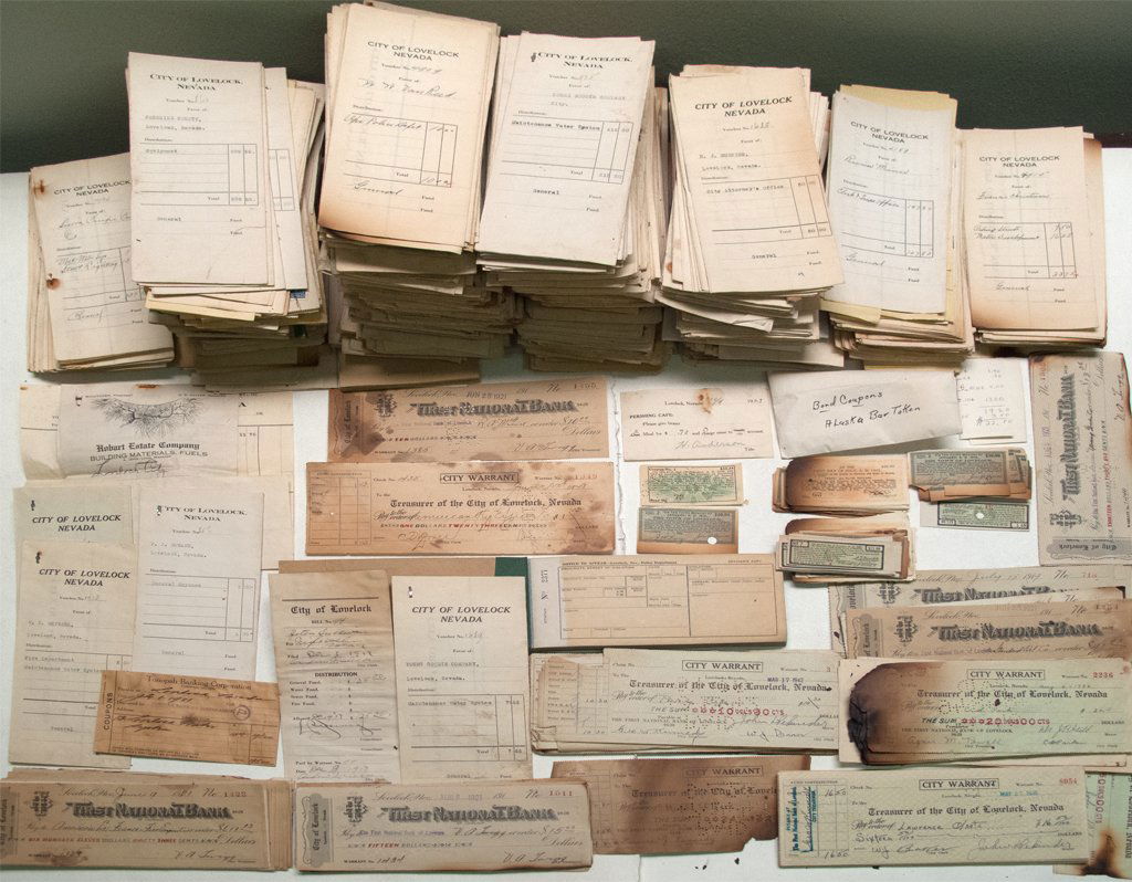 Box full of Lovelock Surprises: This large lot of Lovelock city documents. Includes hundreds and hundreds of vouchers. Many have billheads attached. Unused 1931 ticket book from policeman Richardson. Bond coupons from 1919 through 1