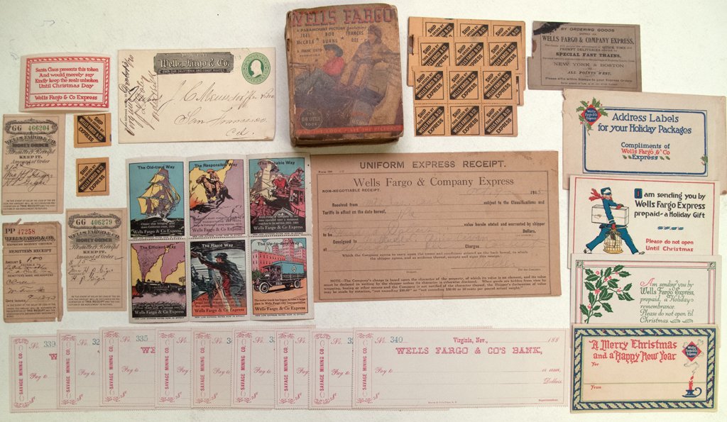 Wells Fargo Ephemera: Eleven pieces of Wells Fargo memorabilia. Shipping stamps, unused checks, Christmas stamps, remitters receipts, advertising stamps, post card, Uniform Express Receipt, souvenir book about the Wells Fa