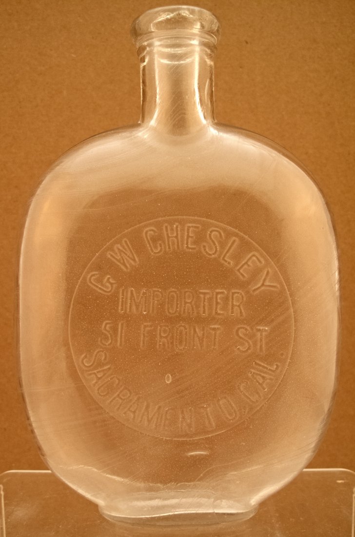 Chesley pumpkin seed whiskey bottle.: G. W. CHELSEY / IMPORTER / 51 FRONT ST / SACRAMENTO, CAL. White, 6 1/2", pumpkin seed. Not in Barnett. c1880