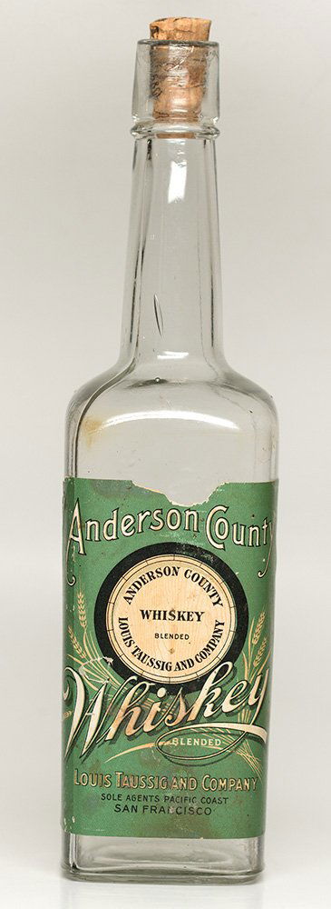Anderson County Blended Whiskey (embossed): Attractive green label on unusual square bottle. Louis Taussig and Company, sole agents on Pacific Coast. Back is embossed Louis Taussig & Co., San Francisco, New York. Rip in label on top. Partial co