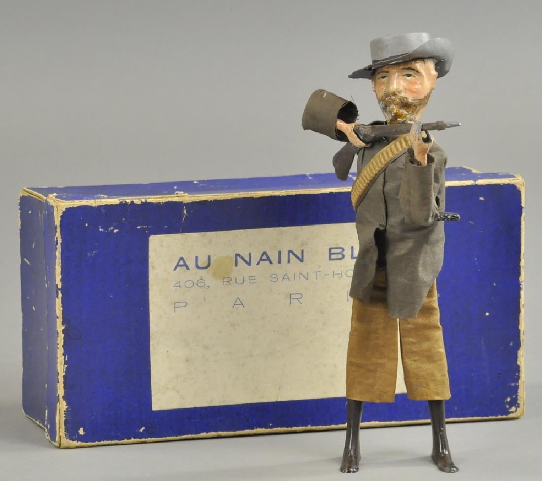 MARTIN "THE VAILLANT BOER": France, tin litho figure dressed in cloth jacket and pants, bullet band across chest and carrying rifle, wears a grey hat which appears to be repainted with a new brim and has some paint enhancement t