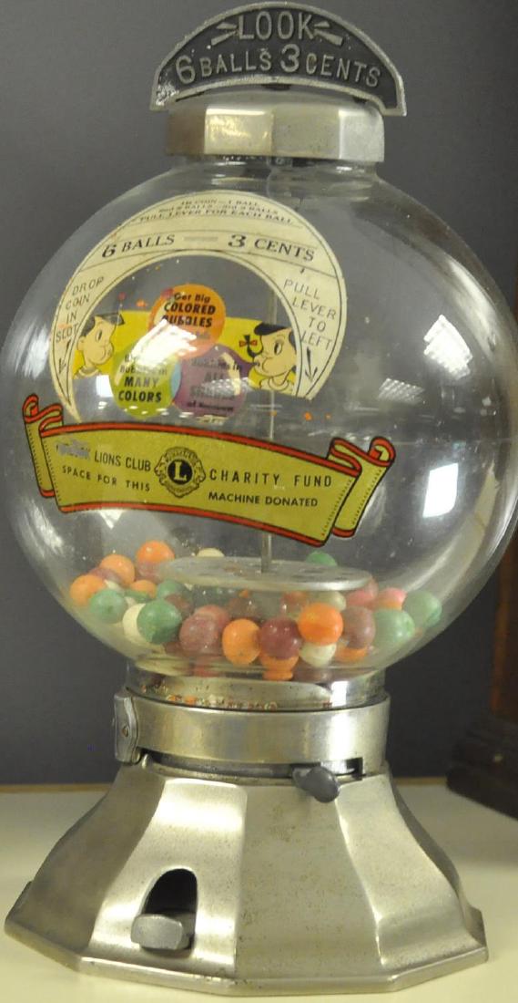 SIX BALLS 3 CENTS BUBBLE GUM MACHINE: The machine still retains the original glass globe with interior decal, metal marquee on the top reads, "Look - 6 balls 3 cents," a wonderful addition to any country store counter. 15" t.