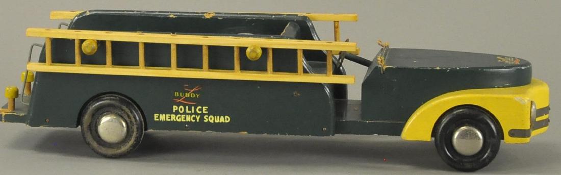 BUDDY L WOOD POLICE EMERGENCY SQUAD: c. 1940's, green and yellow truck, wooden ladders hang at side of body, decals on sides, black wheels. Unusual color with replacement wood ladders, truck needs a little overall repair. 20" length.