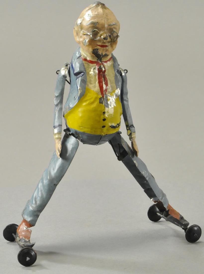 FOXY GRANPA SIDE SKATER: Germany, hand painted tin, action involves arms moving up and down while legs move in and out simulating a kind of roller skating action. 8 1/2" h.