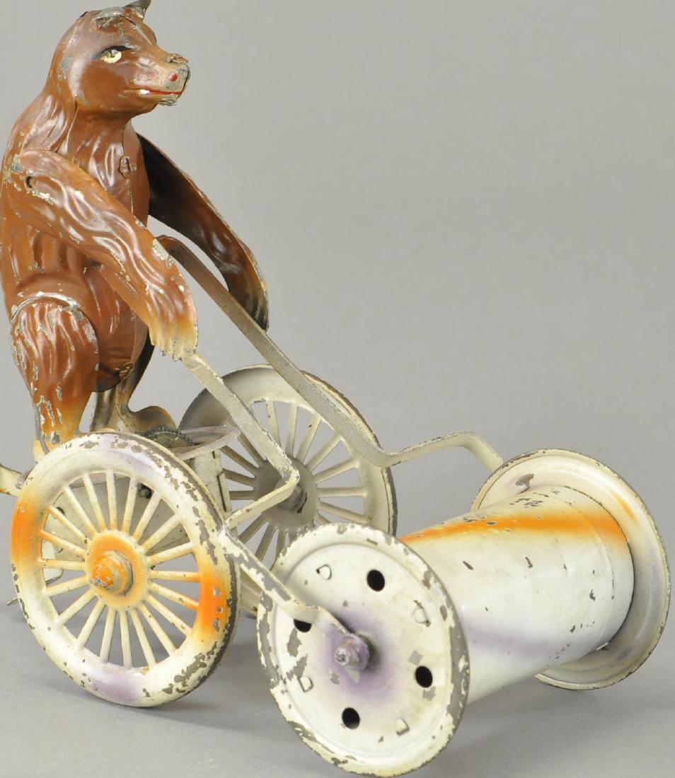 BEAR PUSH MUSICAL ROLLER: Nice spray painted toy, brown bear pushing white musical chime roller, squeeze motion mechanism appears at rear, all original condition. 8 1/2" h.