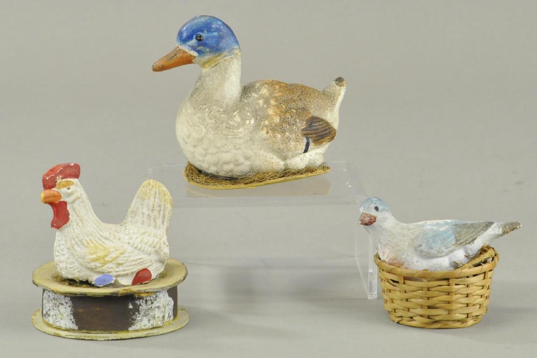 THREE BIRDS ON NEST: Includes duck, dove and chicken, all of German composition and showing a little age appropriate wear. 3" - 4 1/2" h.