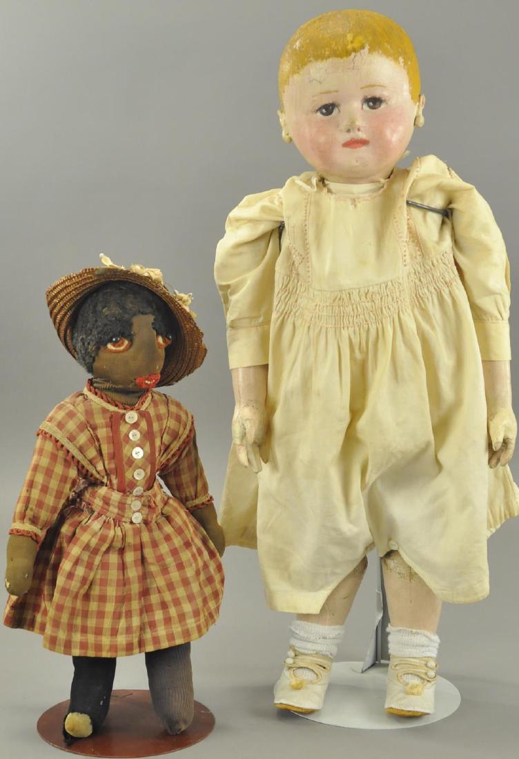 LOT OF TWO CLOTH DOLLS: The larger is a Martha Chase baby with painted face, lower arms and legs, with a stocking net covered body (some age wear and minor paint touch-up on head), along with a black cloth doll with embroide