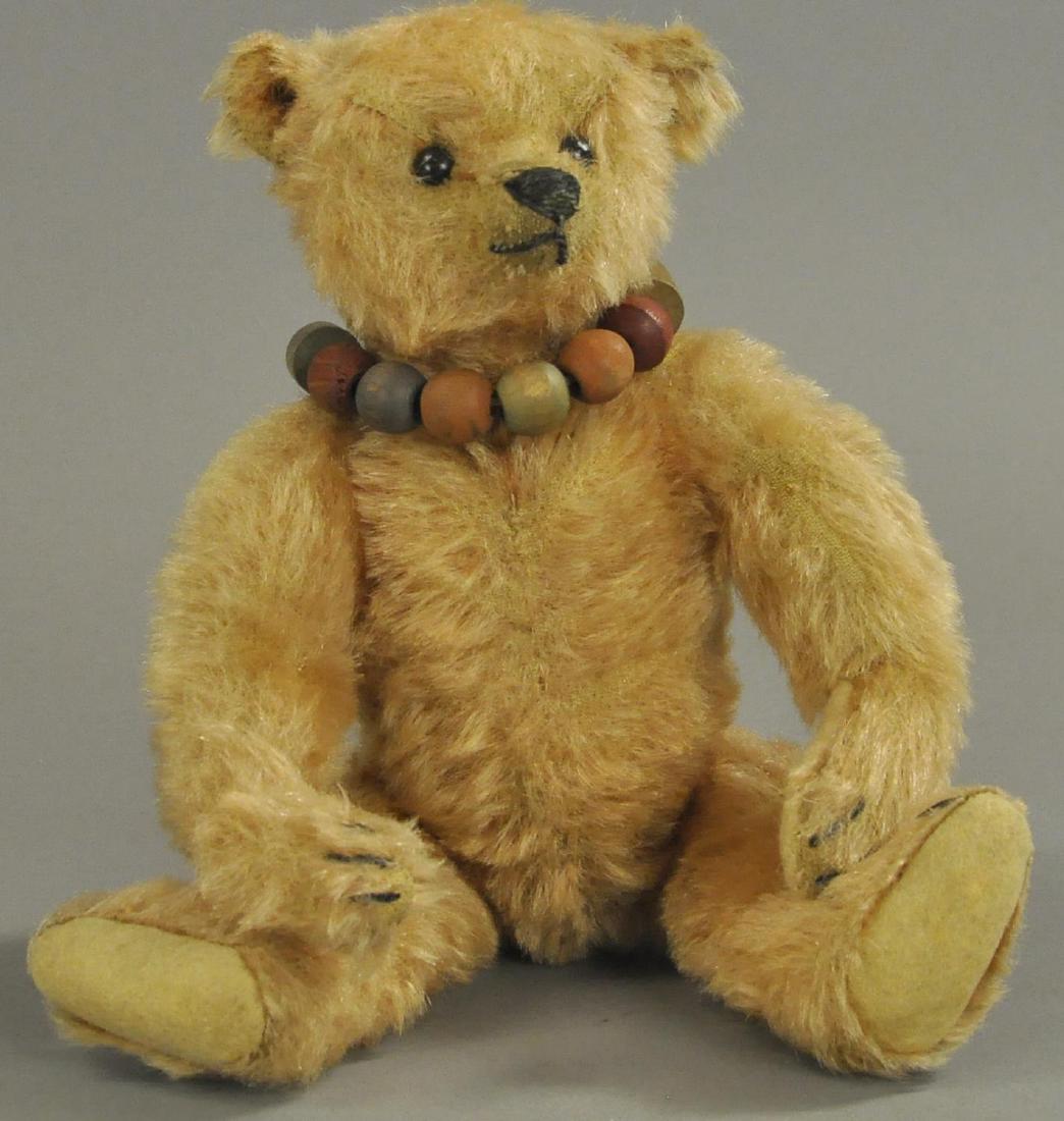 APRICOT STEIFF TEDDY BEAR: c. 1908, beautifully colored, original eyes and nose, one paw pad replaced, a wonderful example. 10" h.