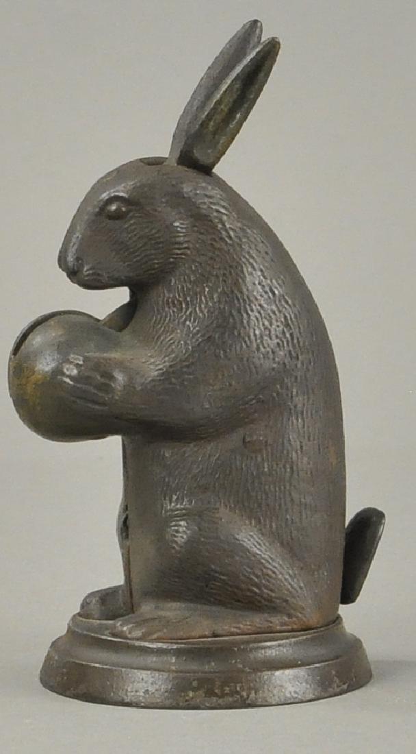 SMALL RABBIT WITH NUT MECHANICAL BANK (1 of 4)