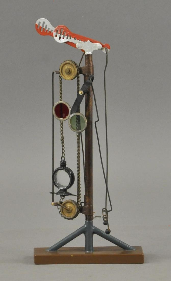 MARKLIN SEMAPHORE: Hand painted tin, red and white signal arm, has signal with glass lens that raise and lowers by chain. 9" X 13" h.