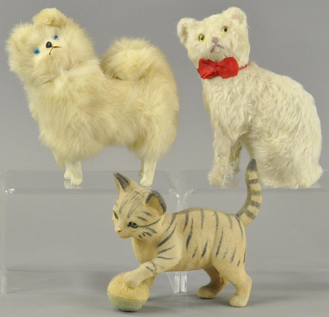 THREE LOVABLE CANDY CONTAINTERS: A Pomeranian dog with big blue eyes, tiger cat with green eyes, and sweet white kitten, all with glass eyes and heads that remove for candy retrieval. 6" - 8" l.